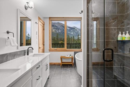 a bathroom with a shower and a sink and a toilet at Spring Creek Luxury - managed by Little Sister Getaways in Canmore