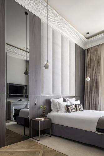une chambre avec un lit king size et une télévision dans l'établissement HIGHSTAY - Luxury Serviced Apartments - Louvre, à Paris