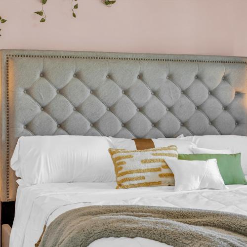 a bedroom with a large bed with white sheets and pillows at Retro Arcade & Gaming Home by Pako Stays in Brampton