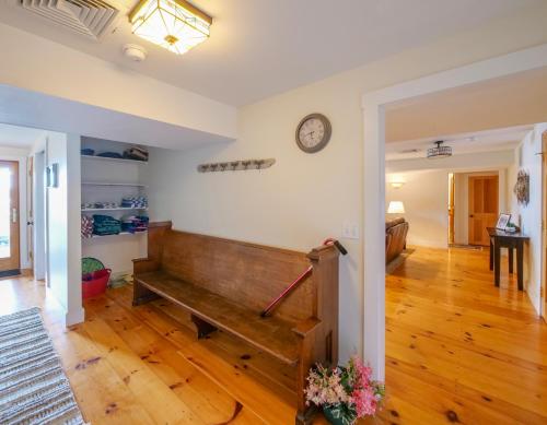 a living room with a bench and a bedroom at The Lakehouse of Braeloch in Colchester