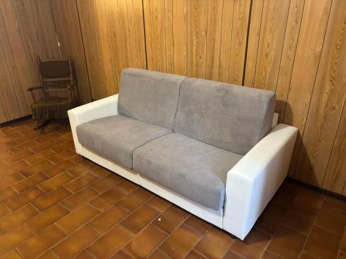 a white couch sitting in a room at Wuthering Heights in Angolo Terme