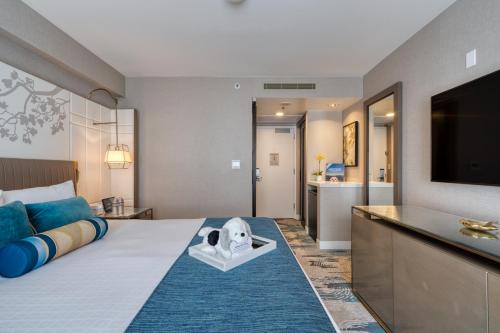 a hotel room with a large bed with a dog on it at Hotel Nikko San Francisco in San Francisco