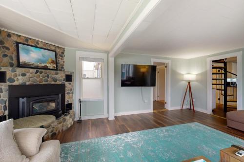 a living room with a fireplace and a tv at Pound House in Hancock