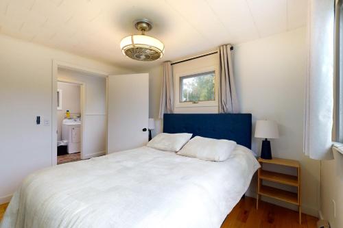 a bedroom with a large white bed and a window at Pound House in Hancock