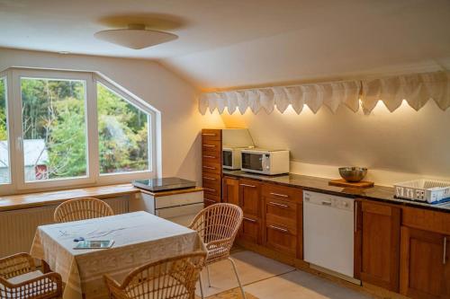 a kitchen with a table and chairs and a microwave at Apartment in recreational area close to the city in Örebro