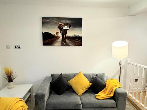 a living room with a couch and a picture of an elephant at Cosy Home in City Centre in Colchester