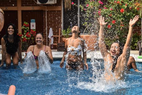 a group of people playing in a swimming pool at Casa Losodeli & Coworking- Adults Only in Puerto Escondido