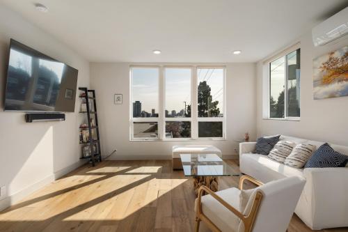 a living room with a white couch and a table at Modern Townhome with Space Needle View in Seattle