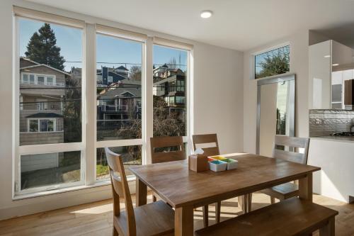 a dining room with a table and a large window at Modern Townhome with Space Needle View in Seattle