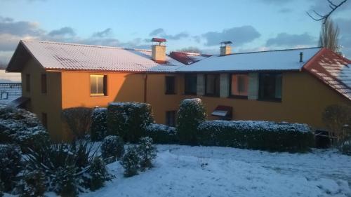 a house with snow on the roof at Penzion U Slunce in Jaroměř