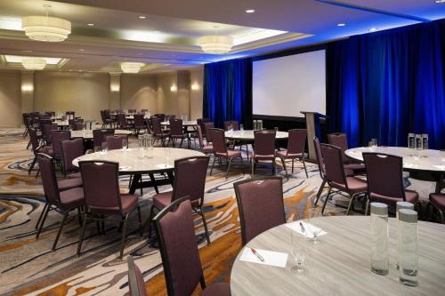 a conference room with tables and chairs and a projection screen at San Diego Marriott Del Mar in San Diego
