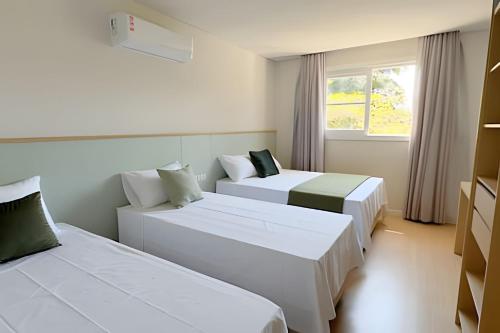 Giường trong phòng chung tại Pousada Encanto da Vila