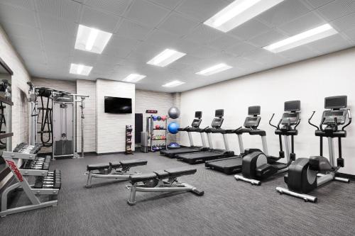 a gym with several treadmills and cardio machines at Courtyard by Marriott Newark Downtown in Newark