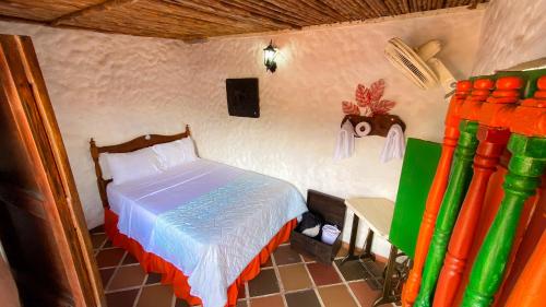 a bedroom with a bed in a room at La Liliana Hostal - Gastrobar in Jagua
