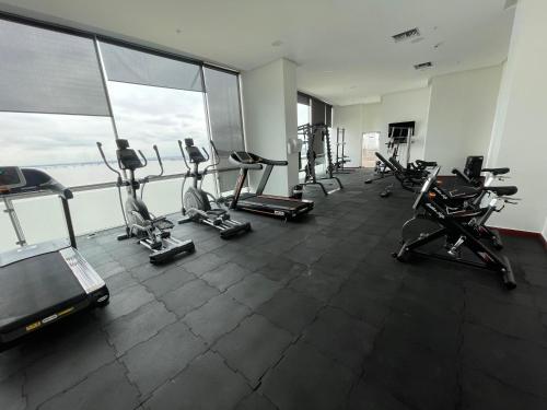 a gym with treadmills and elliptical machines at Gallery Suite en Riverfront Puerto Santa Ana in Guayaquil