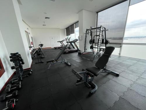 a gym with several treadmills and exercise bikes at Gallery Suite en Riverfront Puerto Santa Ana in Guayaquil