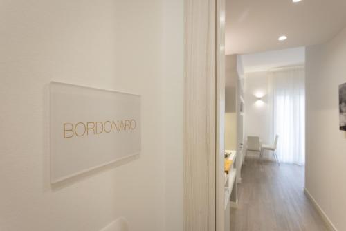 a white room with a sign on a wall at Palermo ai Leoni in Palermo