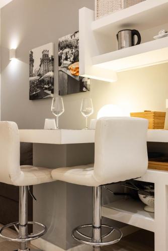 a dining room with white chairs and shelves at Palermo ai Leoni in Palermo