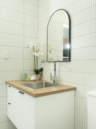 a bathroom with a sink and a mirror at The Resort at Dolphin Heads in Mackay