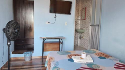 a small room with a bed and a fan at Hotel Villa Salomé LECP in Villagarzón