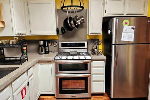 a kitchen with a stainless steel stove and refrigerator at Casa Karina in Santa Fe