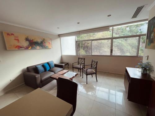 a living room with a couch and a table at Gallery Suite en Riverfront Puerto Santa Ana in Guayaquil