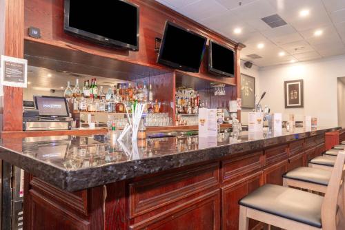 a bar with a granite counter top in a restaurant at Sandman Hotel Lethbridge in Lethbridge