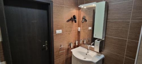 a bathroom with a sink and a mirror at Elite Pension in Štúrovo