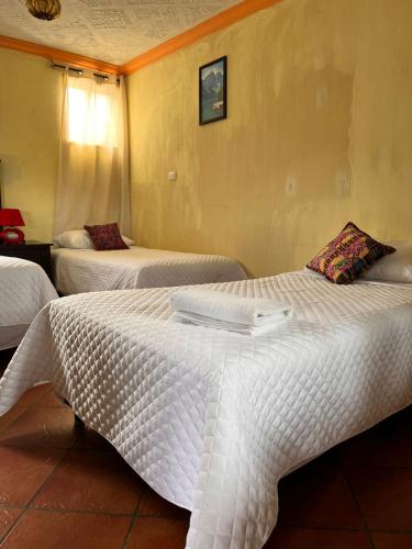 Postel nebo postele na pokoji v ubytování Hotel Makani
