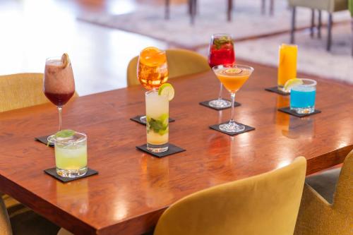 a wooden table with four different types of drinks at Holiday Inn Porto Gaia by IHG in Vila Nova de Gaia