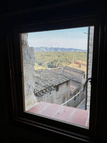 a view from a window of an old building at Rural Stone House with wood fireplace in Pinell de Bray