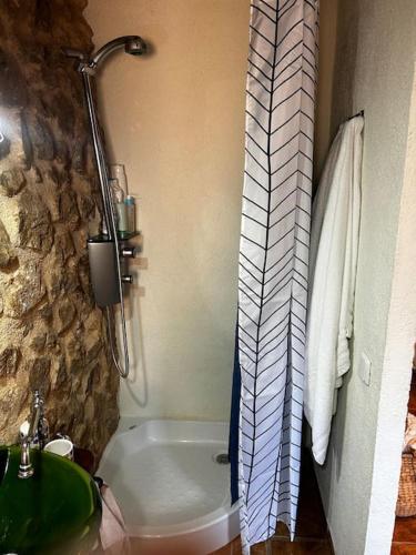 a bathroom with a bath tub and a sink at Rural Stone House with wood fireplace in Pinell de Bray