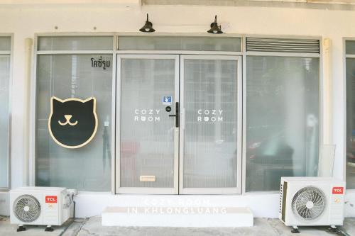 a glass door with a cat sign on it at Cozy room in Khlongluang II - Self Check-in in Khlong Luang