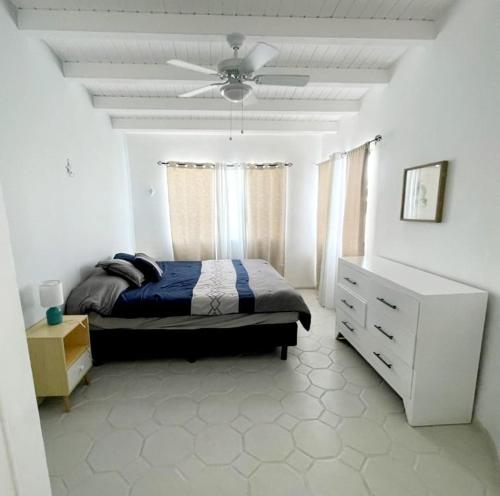 a bedroom with a bed and a ceiling fan at Ocean view house - Plaza del Mar in Rosarito