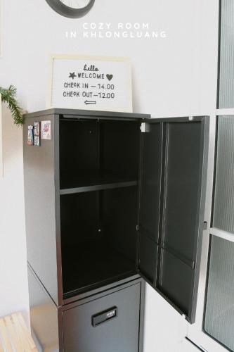 a refrigerator with a sign on top of it at Cozy room in Khlongluang - Self Check-in in Khlong Luang