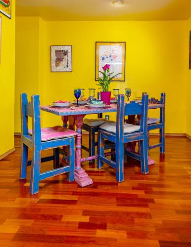a dining room with a blue table and chairs at Casa Karina in Santa Fe