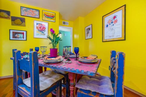 a dining room with yellow walls and a table and chairs at Casa Karina in Santa Fe