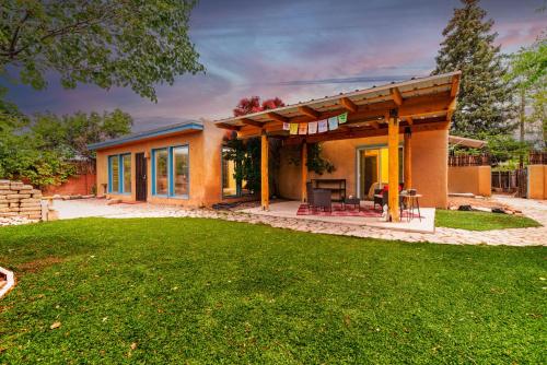 a house with a patio and a yard at Casa Karina in Santa Fe