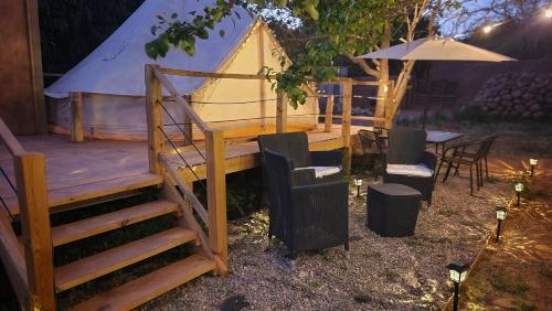 a gazebo with a table and chairs and a tent at Glamping Dunas del sol in San Pedro de Atacama