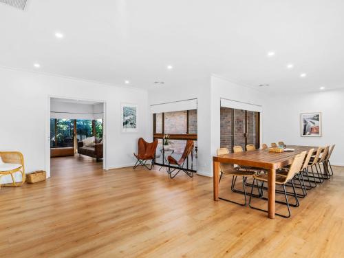 a dining room and living room with a table and chairs at Retreat House in Yarrawonga
