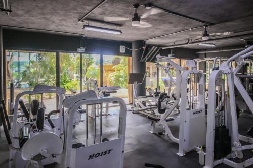 a gym with rows of treadmills and machines at Top Location Studio with Rooftop Pool, Gym and Padel Court in Tulum