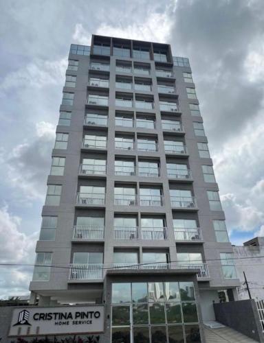 a tall building with a sign in front of it at Flat Alto Padrão 3 in Campina Grande