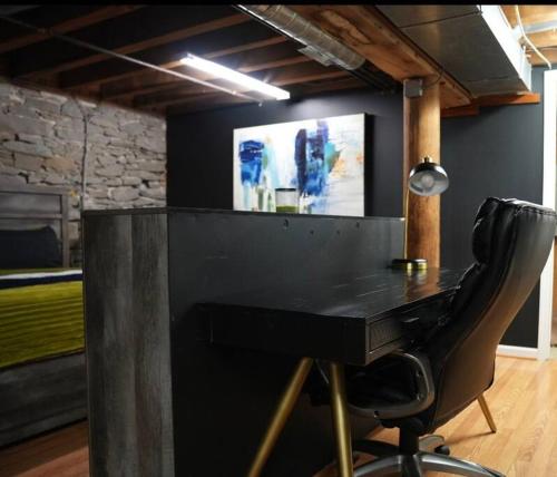 a black desk with a chair in a room at The love loft on the waterfree parking downtown in Troy