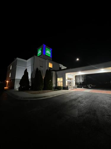 a gas station with a lit up sign at night at Wingate by Wyndham I-81 Exit 101- Newly Renovated in Dublin