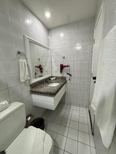 a bathroom with a sink and a toilet and a mirror at Flat Meireles, Vista Mar, Avenida Abolição AP 1307 , 1404 in Fortaleza