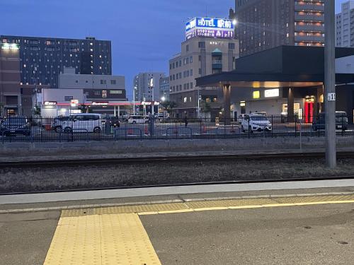 a train station in a city at night at Business Hotel Ekimae in Hakodate