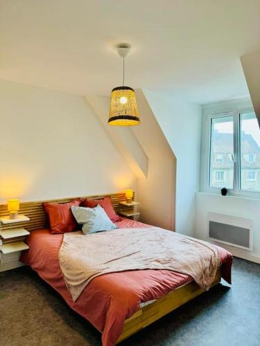 - une chambre avec un lit doté d'oreillers rouges et d'une lampe dans l'établissement Au Plagiste, 8 pers, proche mer, garage, à Le Portel