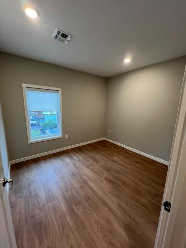an empty room with wooden floors and a window at 322 Brand New 2 Bdr 1 KIT 2 BTH 1 LIV in Dunellen