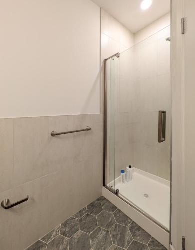 a bathroom with a shower and a tub and a sink at 213 Brand New 3 Bedroom 2 Bath 1 Full Kit 1 Liv in Dunellen