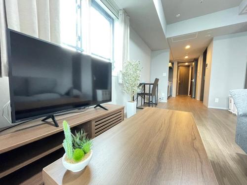 a living room with a large flat screen tv at 1101 札幌中心部 アクセス最高 すすきの駅より徒歩5分 in Sapporo